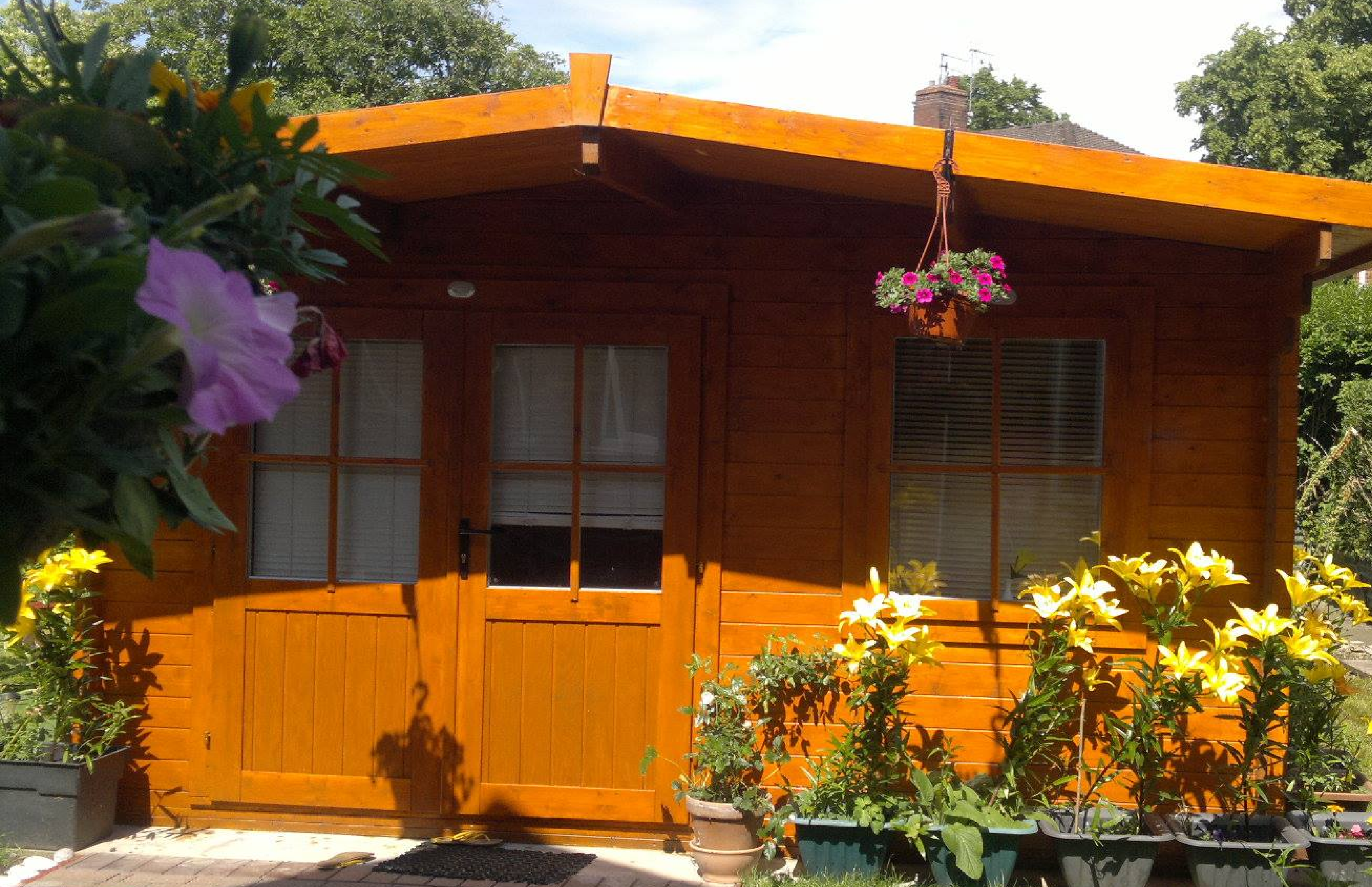 The log cabin massage studio in its garden at 8 Withies Road, Stoke-on-Trent, around ten minutes from Newcastle-under-Lyme